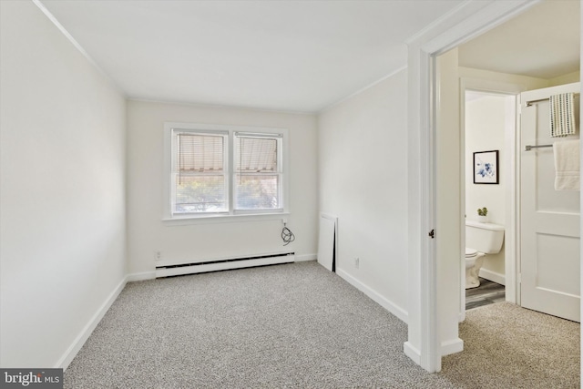 empty room with carpet and a baseboard heating unit