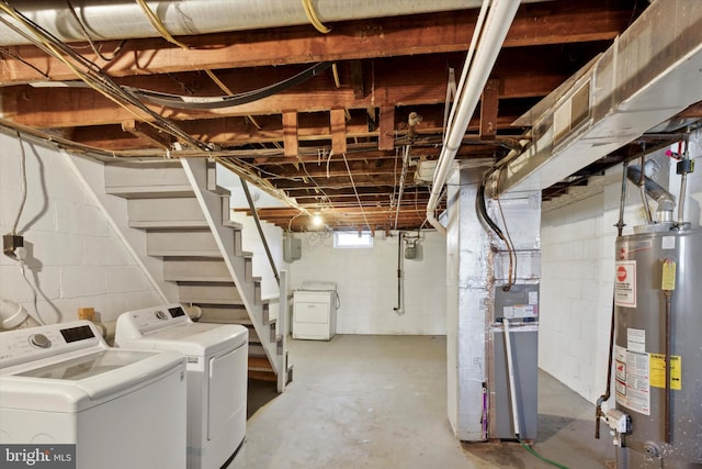 basement featuring washer and clothes dryer, gas water heater, and heating unit