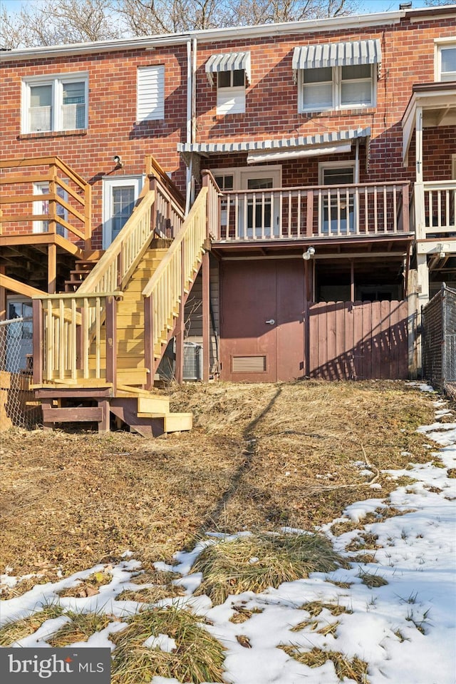 snow covered property featuring a deck