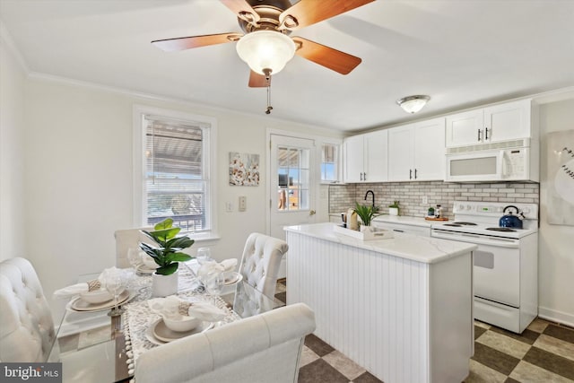 kitchen featuring sink, white cabinets, decorative backsplash, crown molding, and white appliances