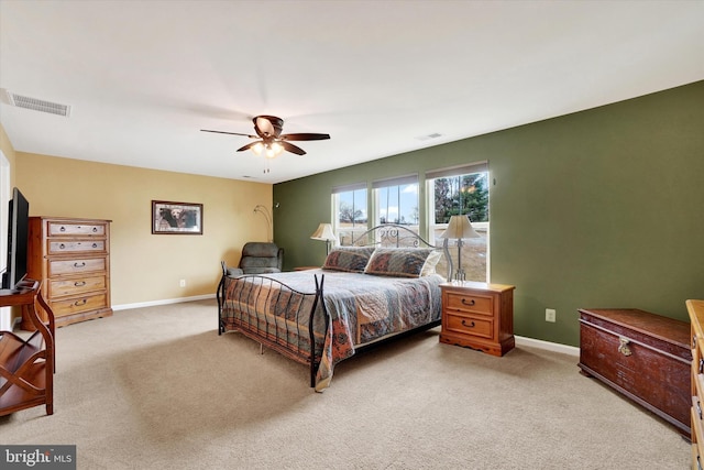 bedroom with ceiling fan and light carpet