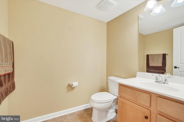 bathroom with tile patterned floors, vanity, and toilet