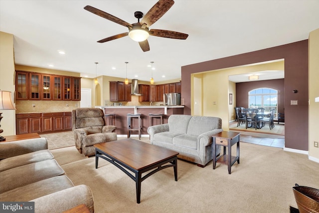 living room featuring ceiling fan and light colored carpet