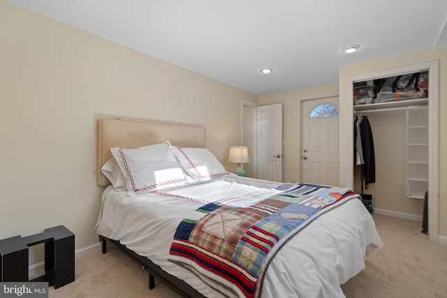 bedroom with light colored carpet and a closet