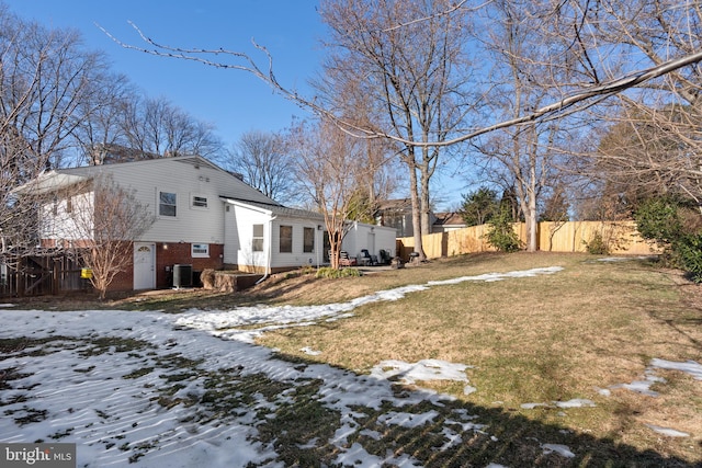 yard covered in snow featuring central air condition unit