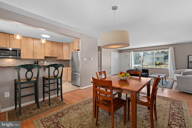 dining space with light hardwood / wood-style flooring