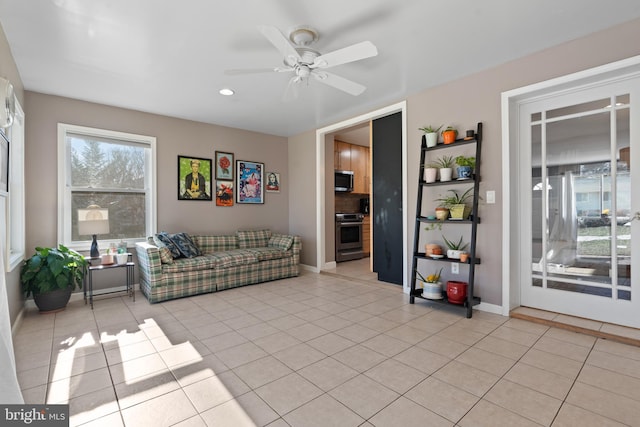 living room featuring light tile patterned floors and ceiling fan