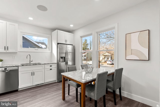 dining room with dark hardwood / wood-style floors and sink