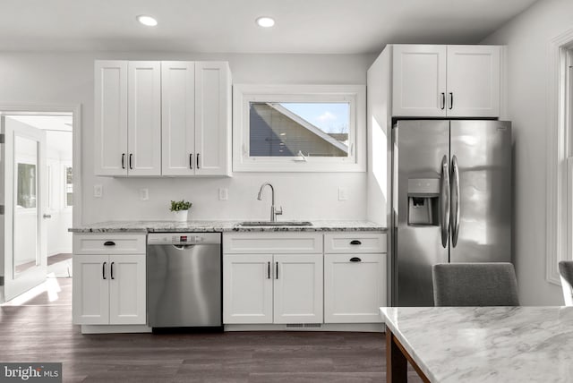 kitchen with stainless steel appliances, sink, and white cabinets