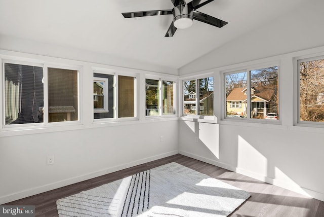 sunroom featuring ceiling fan, vaulted ceiling, and a wealth of natural light