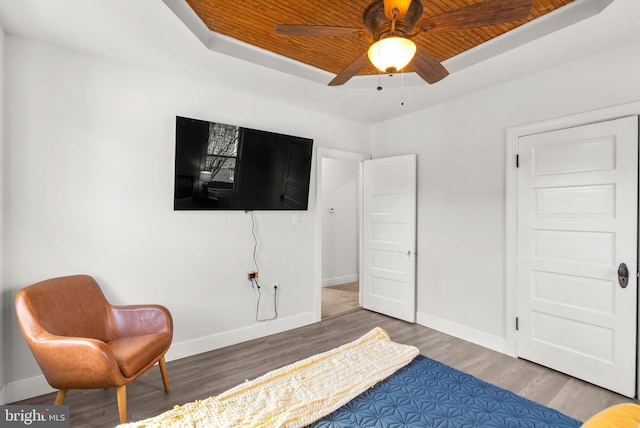 bedroom with dark hardwood / wood-style flooring, wood ceiling, and ceiling fan