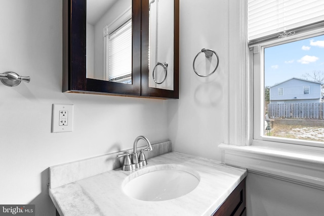 bathroom with plenty of natural light and vanity