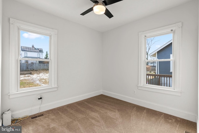 unfurnished room featuring ceiling fan and carpet flooring