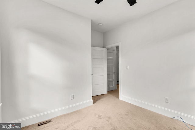 unfurnished bedroom with light carpet and ceiling fan