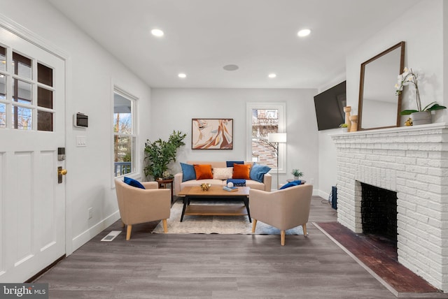 living room featuring dark hardwood / wood-style flooring and a fireplace