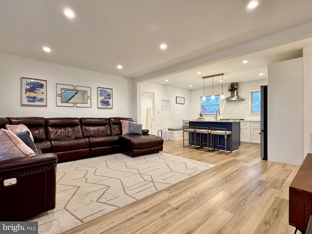 living room with sink and light wood-type flooring