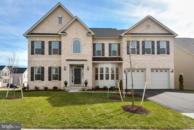 view of front of property with a garage, a front yard, aphalt driveway, and brick siding