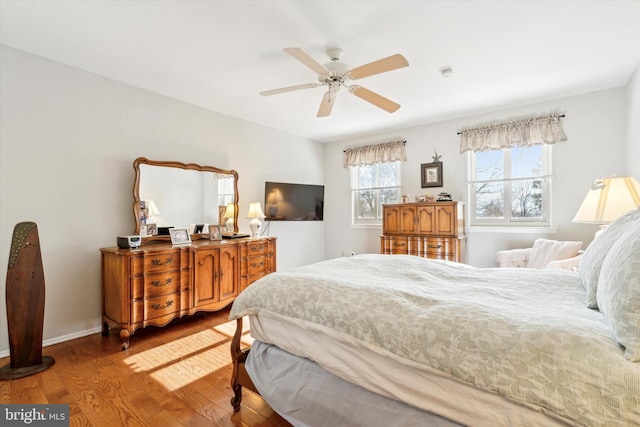 bedroom with hardwood / wood-style flooring and ceiling fan