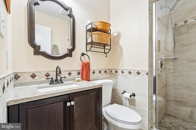 bathroom featuring vanity, tile walls, an enclosed shower, and toilet