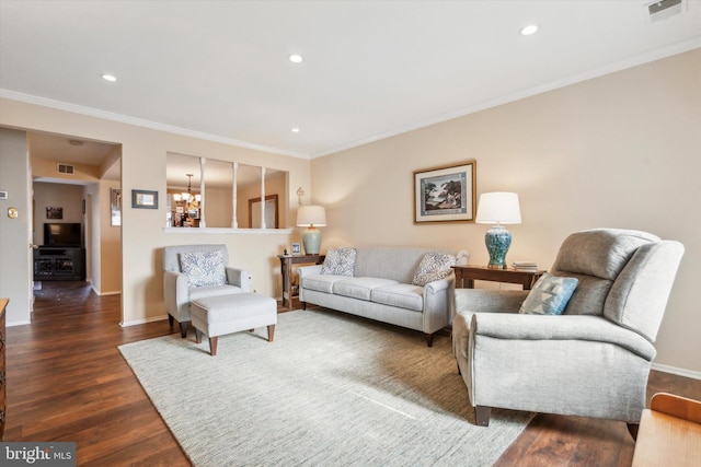 living room featuring an inviting chandelier, crown molding, and dark wood-type flooring