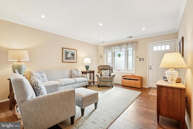 living room with ornamental molding and dark hardwood / wood-style floors