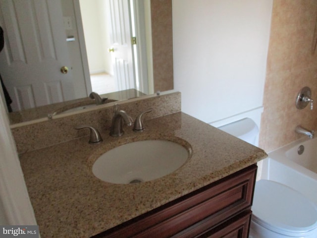 full bathroom with shower / bathtub combination, vanity, and toilet