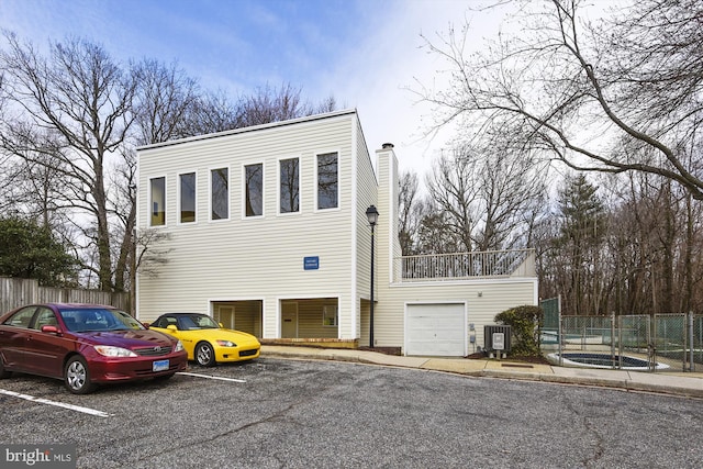 view of front facade featuring a garage and central AC