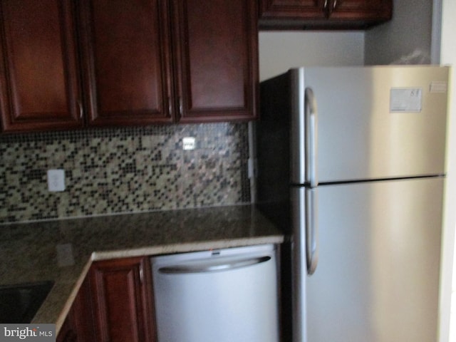 kitchen with tasteful backsplash and appliances with stainless steel finishes