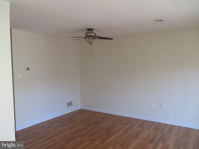 empty room featuring ceiling fan and dark hardwood / wood-style flooring