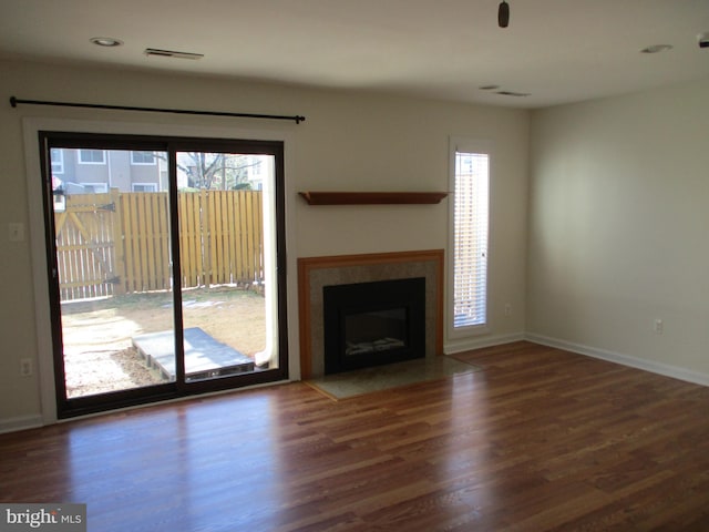 unfurnished living room featuring dark hardwood / wood-style flooring