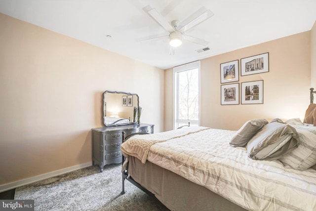 carpeted bedroom with visible vents, baseboards, and a ceiling fan