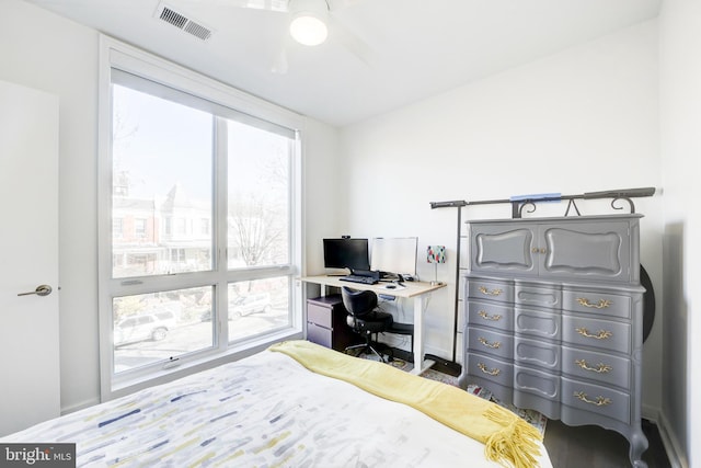 bedroom featuring ceiling fan, multiple windows, and visible vents