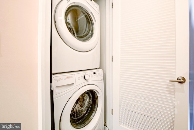 clothes washing area with laundry area and stacked washer and clothes dryer