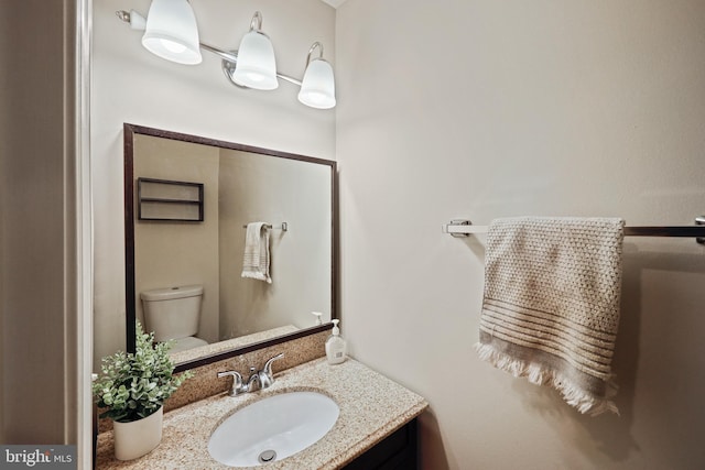 bathroom with vanity and toilet