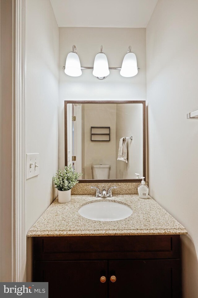 bathroom featuring vanity and toilet