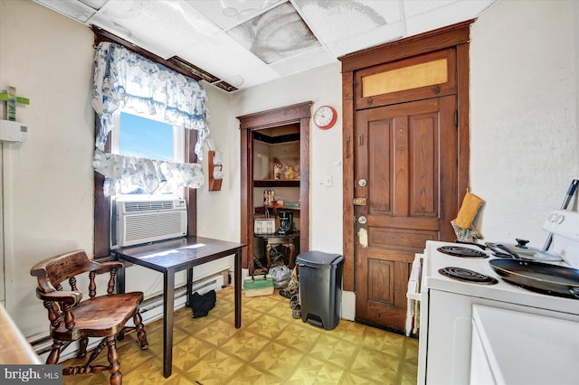 kitchen featuring cooling unit, white range with electric cooktop, a paneled ceiling, and a baseboard heating unit