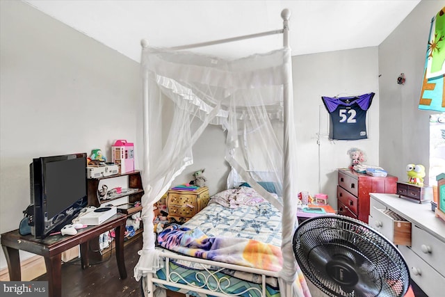 bedroom with hardwood / wood-style flooring