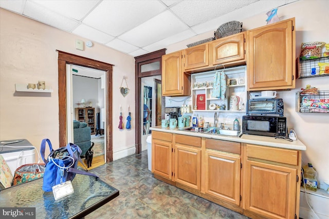 kitchen with sink and a paneled ceiling