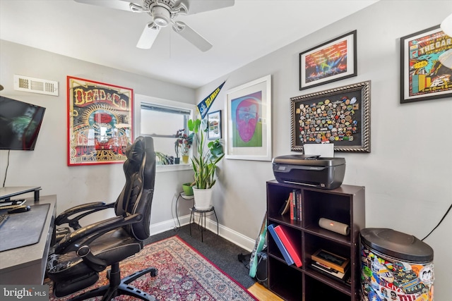 carpeted office with ceiling fan