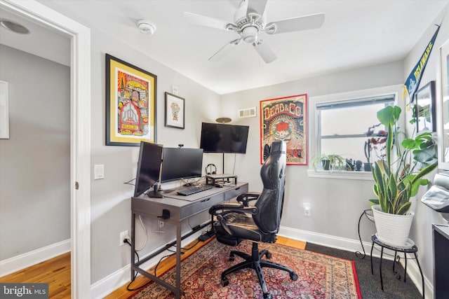 office space with hardwood / wood-style flooring and ceiling fan