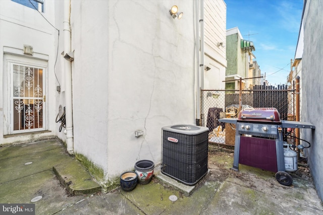 view of side of property featuring central AC and a patio area