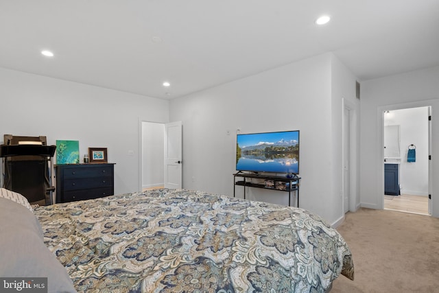 carpeted bedroom featuring connected bathroom