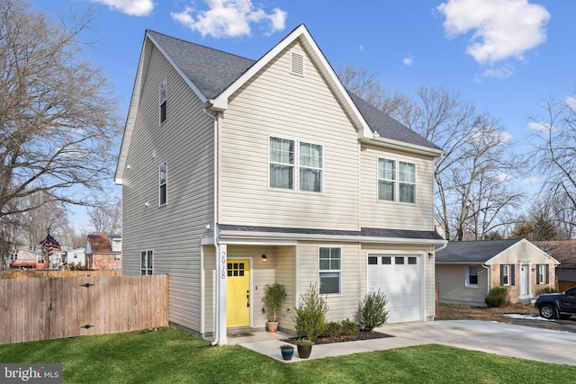 view of front of house featuring a garage and a front lawn