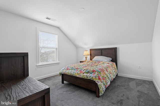 carpeted bedroom with lofted ceiling