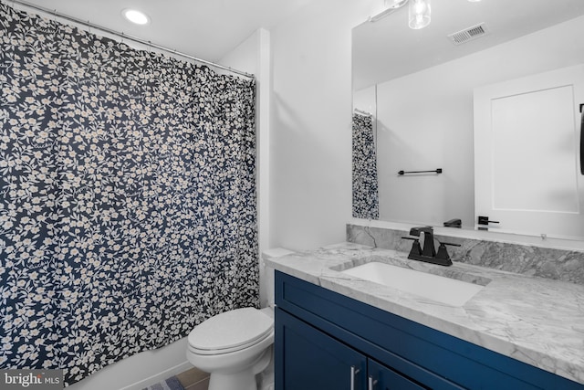 bathroom with vanity, toilet, and curtained shower