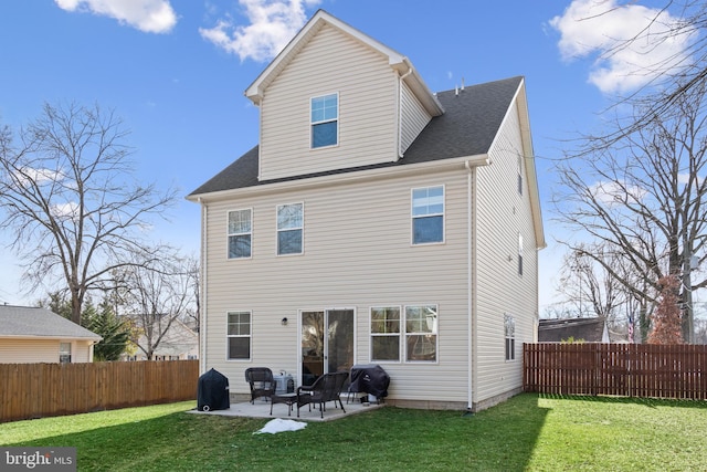 rear view of property featuring a patio area and a lawn