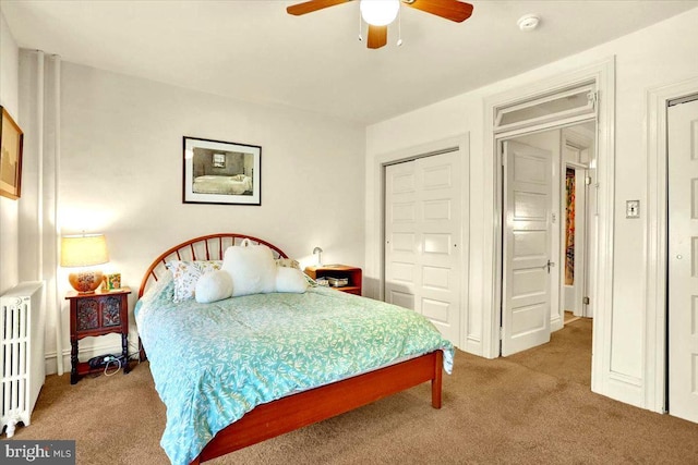 carpeted bedroom featuring ceiling fan and radiator heating unit