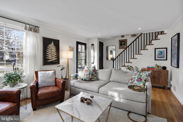 living room featuring hardwood / wood-style flooring and ornamental molding