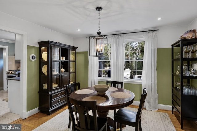 dining space with an inviting chandelier and light wood-type flooring