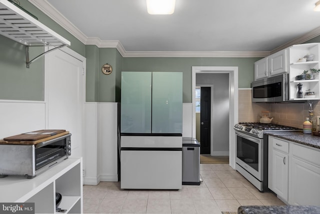 kitchen featuring crown molding, stainless steel appliances, white cabinets, and light tile patterned flooring